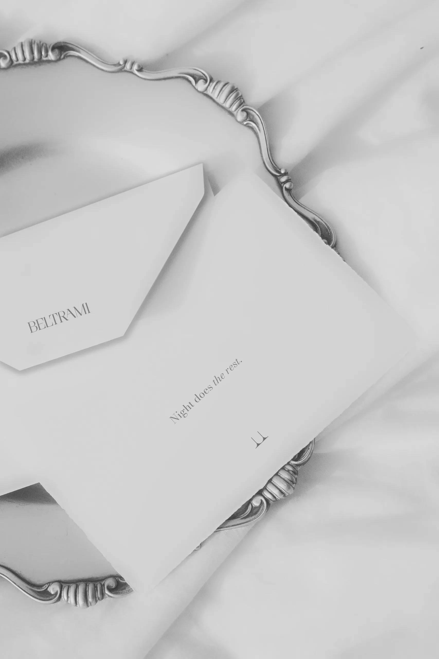 Beltrami correspondence card and envelope arranged on a silver tray
